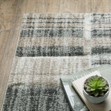 8' X 11' Ivory Beige Grey Brown Pale Blue And Charcoal Geometric Power Loom Stain Resistant Area Rug